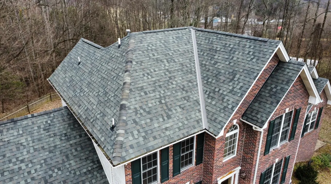 Two-story brick home with a new grey shingle roof by White's Roofing Co in Bristol, TN