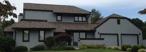Grey two-storey home with a new shingle roof by White's Roofing Co in Bristol, TN