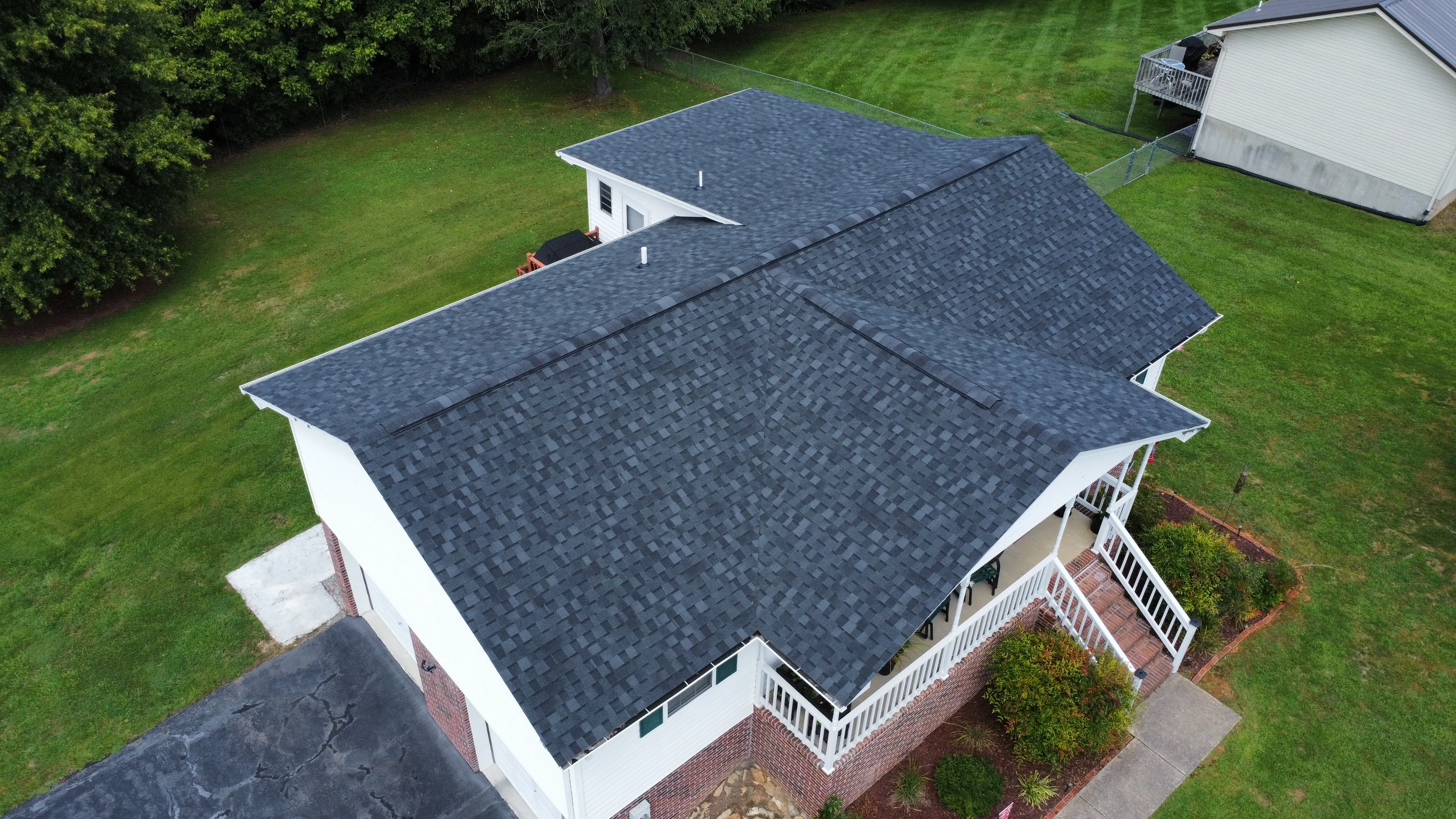 Home with a grey dimensional shingle roof and front porch - roofing in Bristol, TN