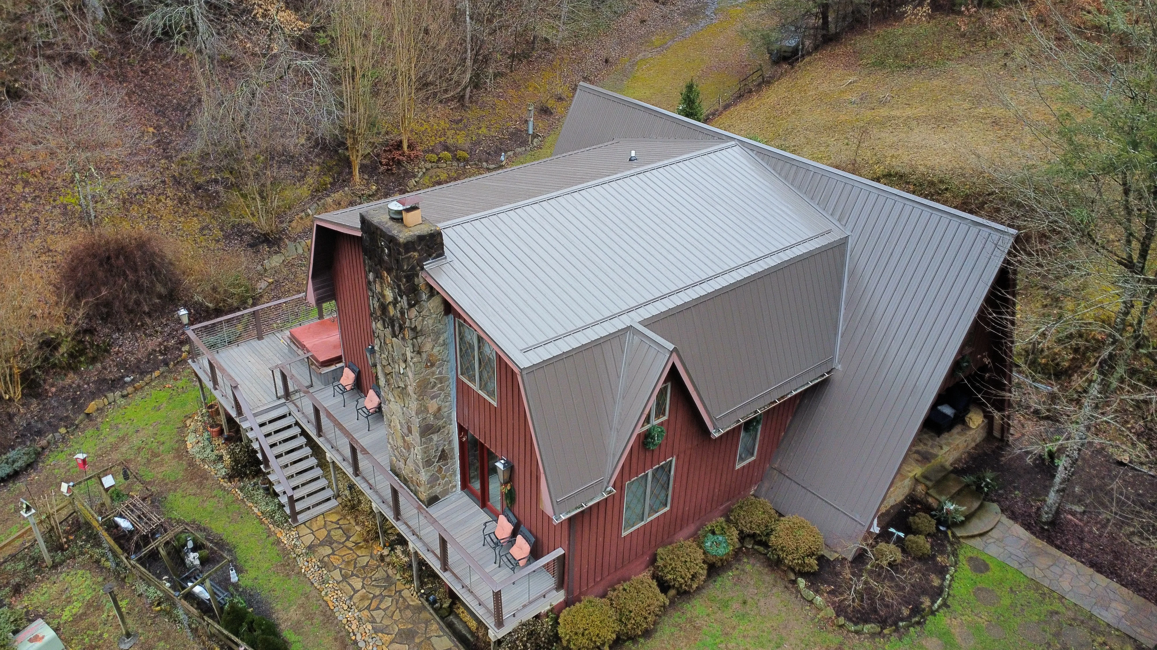 Red-sided cabin with a brown standing-seam metal roof - roofing in Bristol, TN