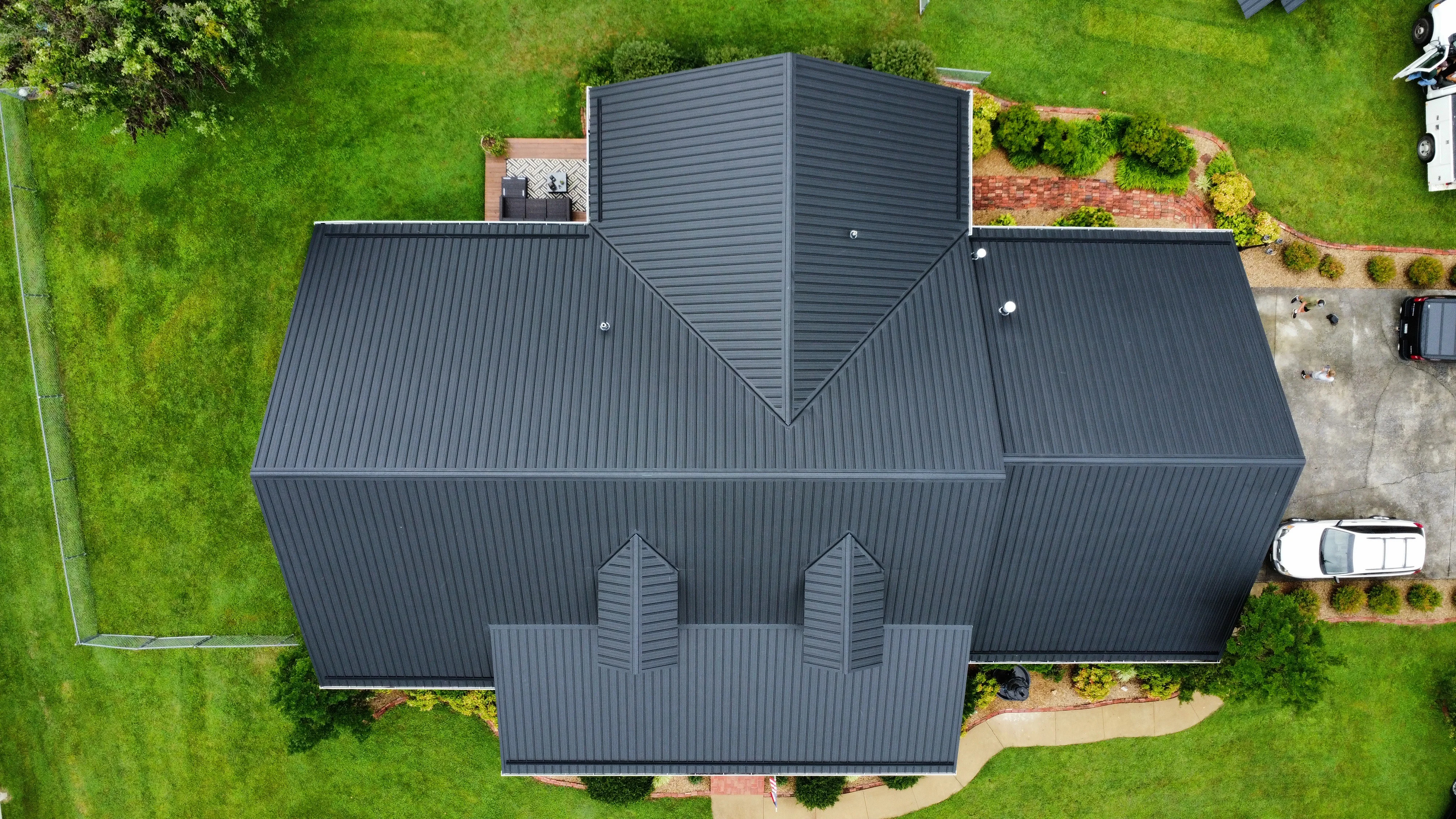 Modern home with a dark standing-seam metal roof - roofing in Bristol, TN