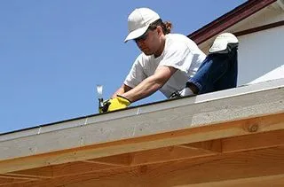 Roofer nailing shingles along a roof edge in Bristol, TN
