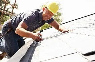 Roofer fastening underlayment during a roof installation in Bristol, TN